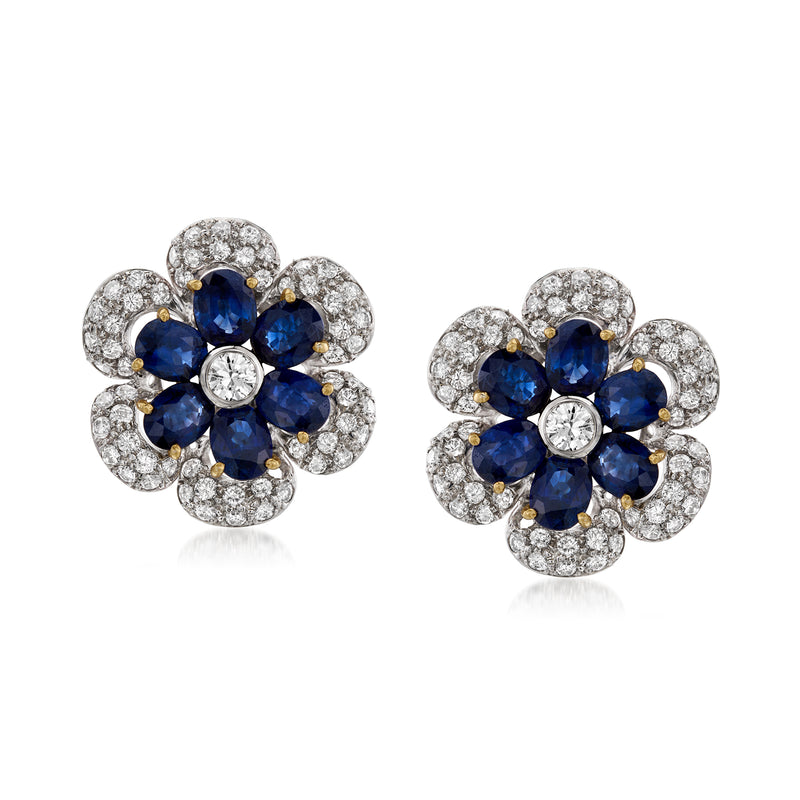 Two-tone gold flower stud earrings with blue sapphire centers and diamond halos