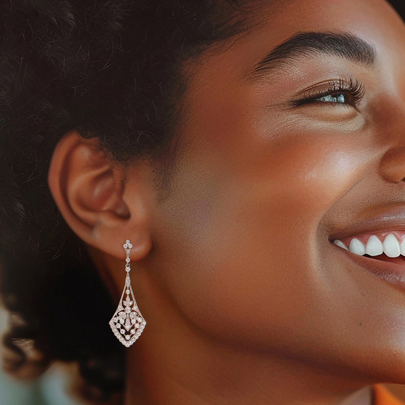 Diamond drop earrings in platinum on a model's ear