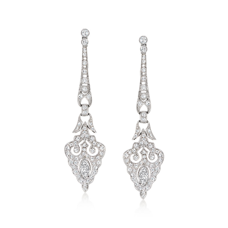 White gold diamond drop earrings with teardrop dangle and ornate center motif