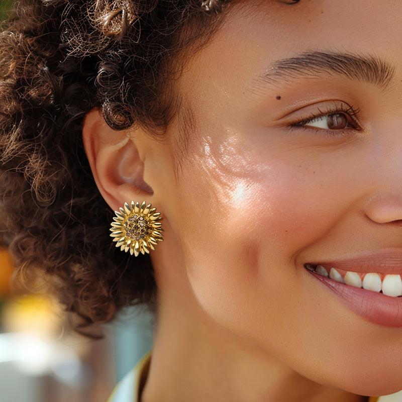 Sunflower gold earrings with brown center stones on model