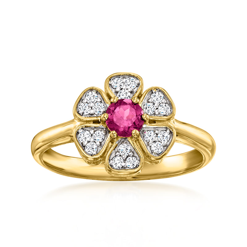 Gold flower ring with oval pink center stone and five white topaz accents