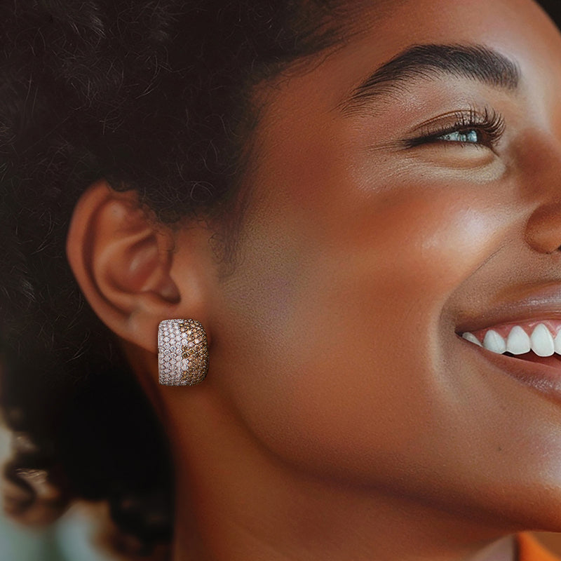 Cushion-shaped two-tone diamond earrings on ear, white and brown stones in white gold