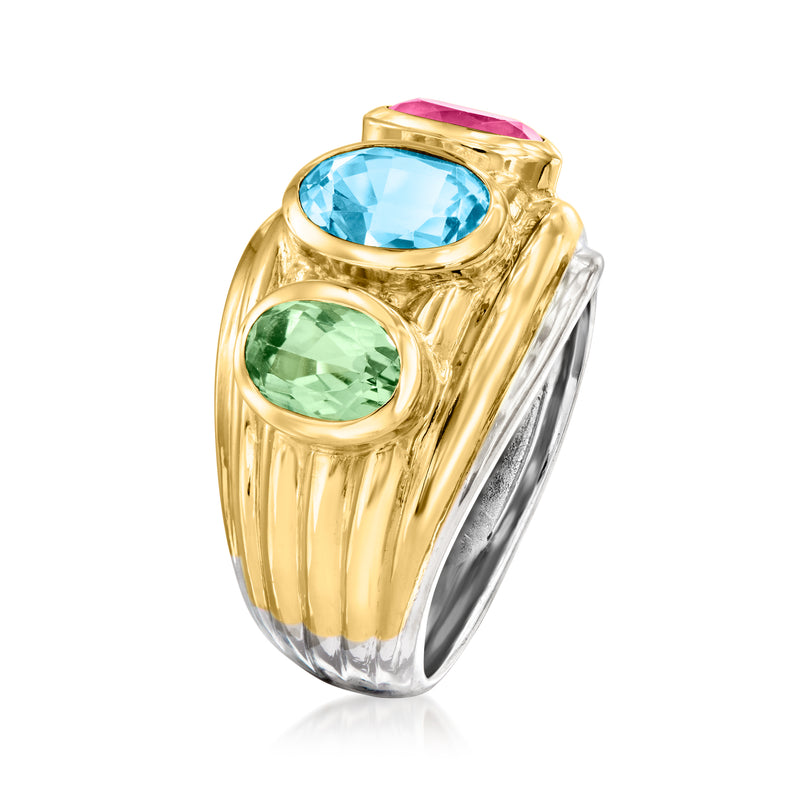 Two-tone gold ring with oval blue stone, oval green stone, and pink accent