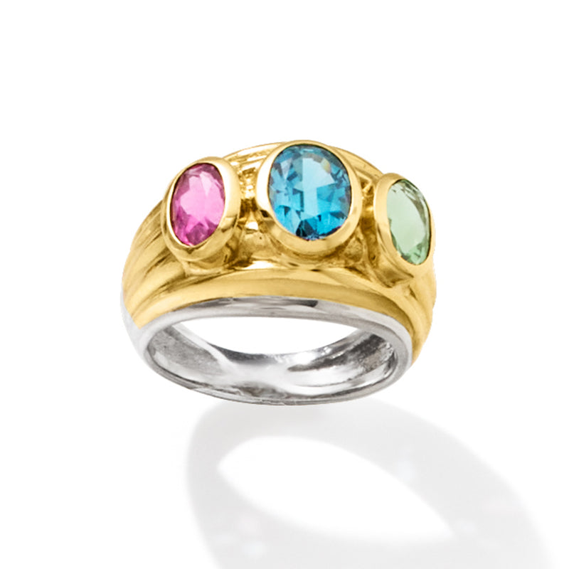 Two-tone gold ring featuring round pink, oval blue, and oval green gemstones