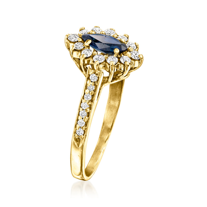 Vintage yellow gold ring featuring an oval blue sapphire with diamond cluster design