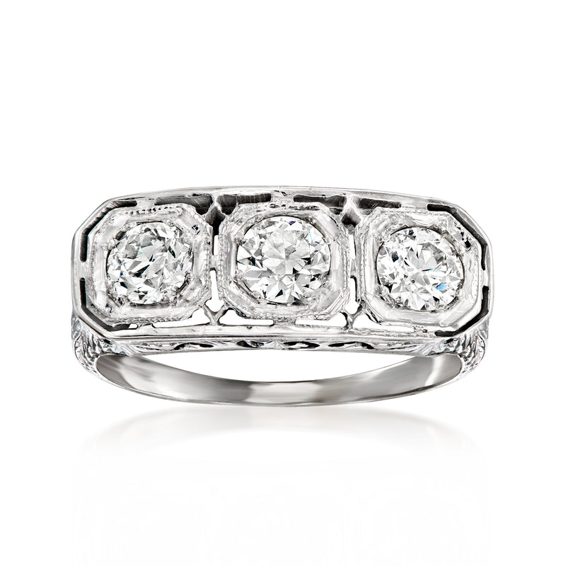 Vintage white gold diamond ring with three round-cut stones and filigree setting