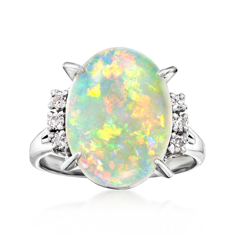 Vintage opal and diamond ring in platinum with oval opal center and diamond side clusters