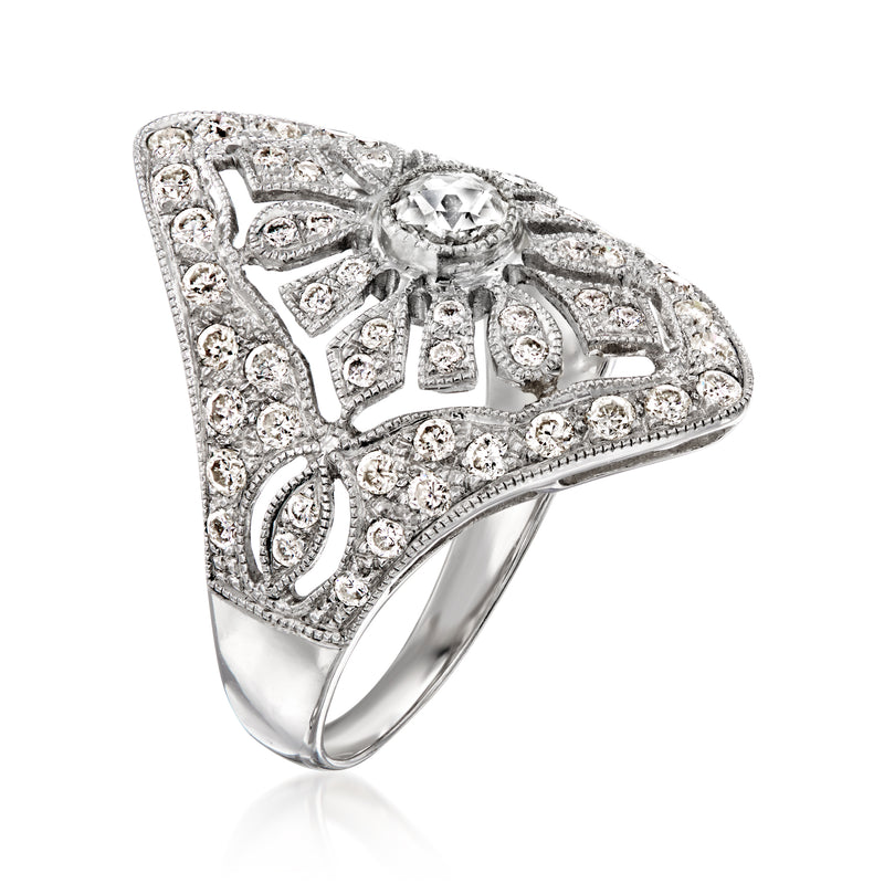 White gold vintage ring with side filigree and round diamond accents around center stone
