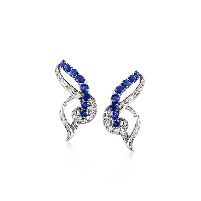 Platinum swirl clip-on earrings with sapphire and diamond accents, curved setting