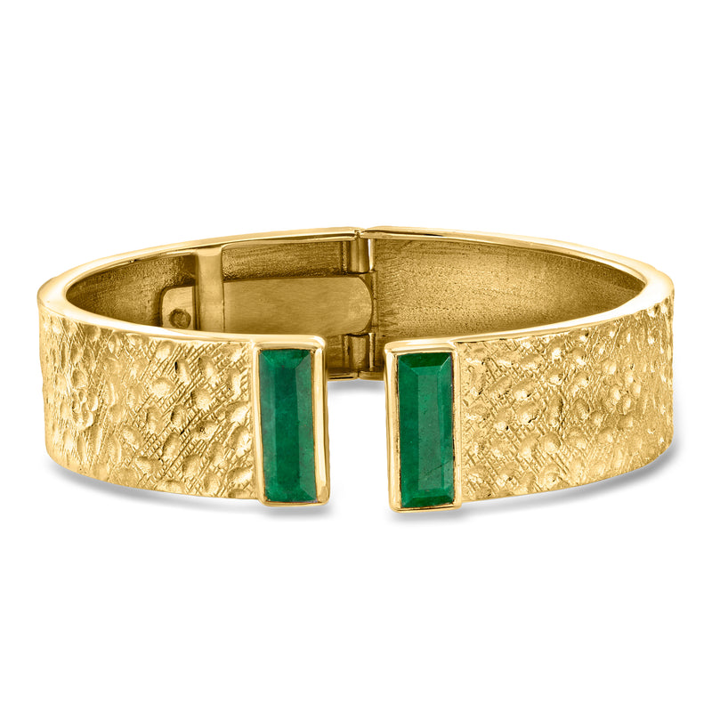 Gold emerald cuff bracelet with textured finish and two square green stones, hinged clasp
