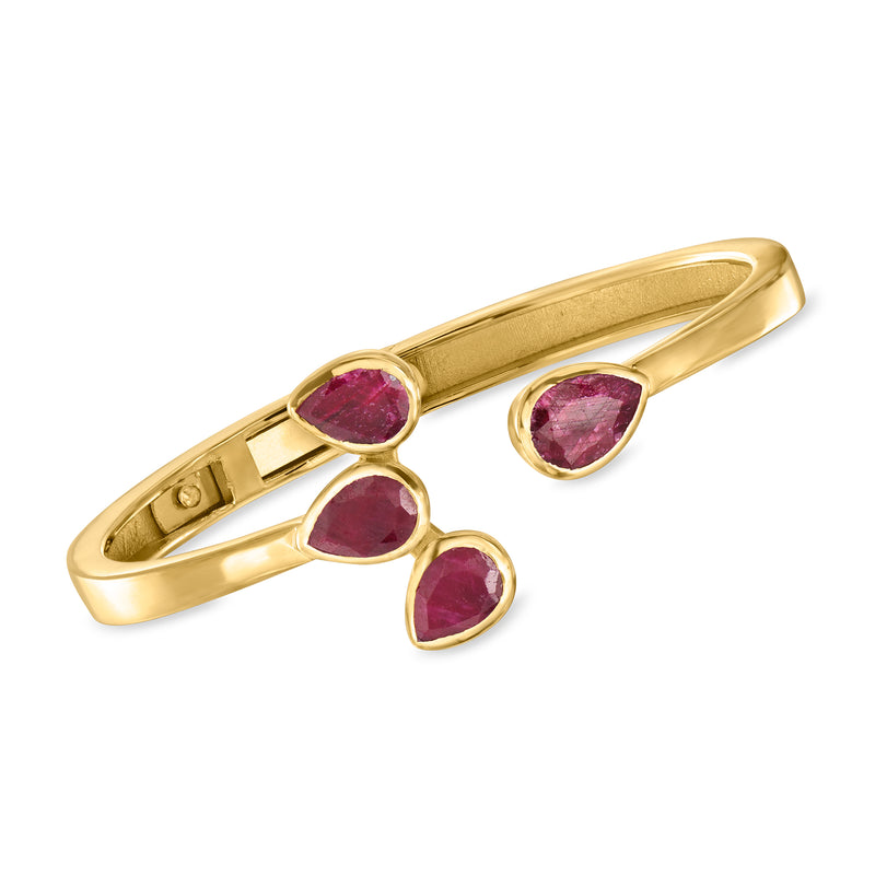 Gold cuff bracelet with five round ruby-colored gemstones in open settings