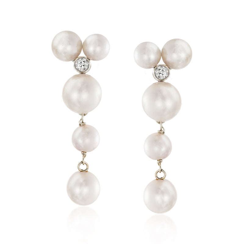 Cultured pearl drop earrings: three white pearls with diamond top on white gold posts