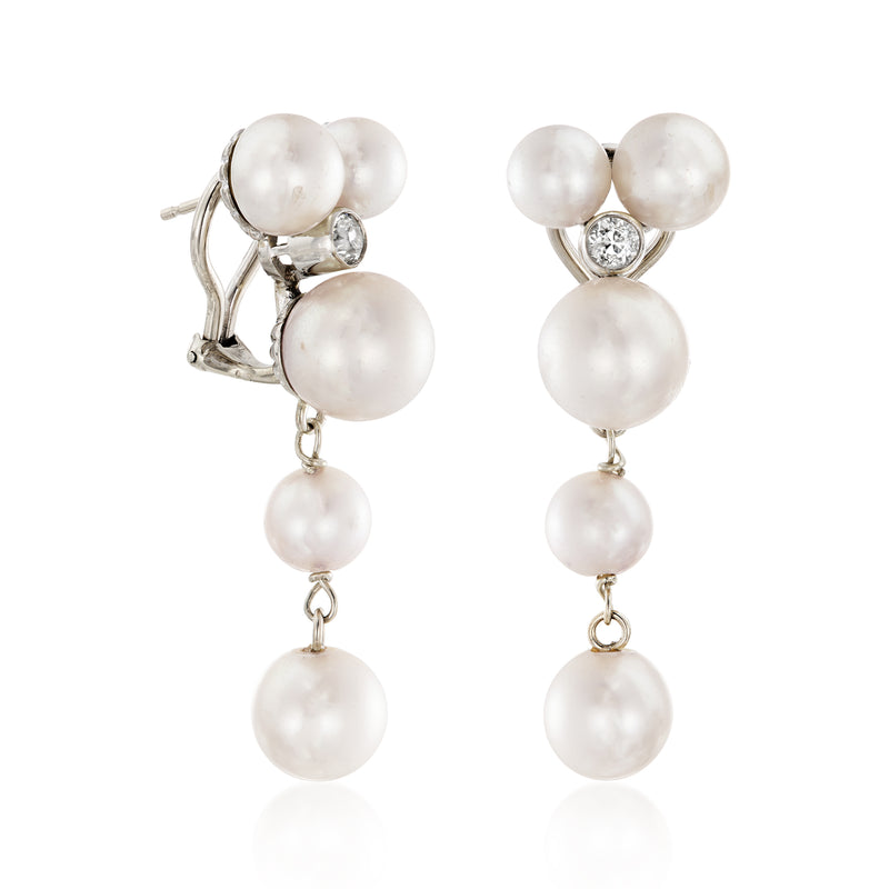 Pearl drop earrings side view: white gold posts with three dangling pearls and diamond