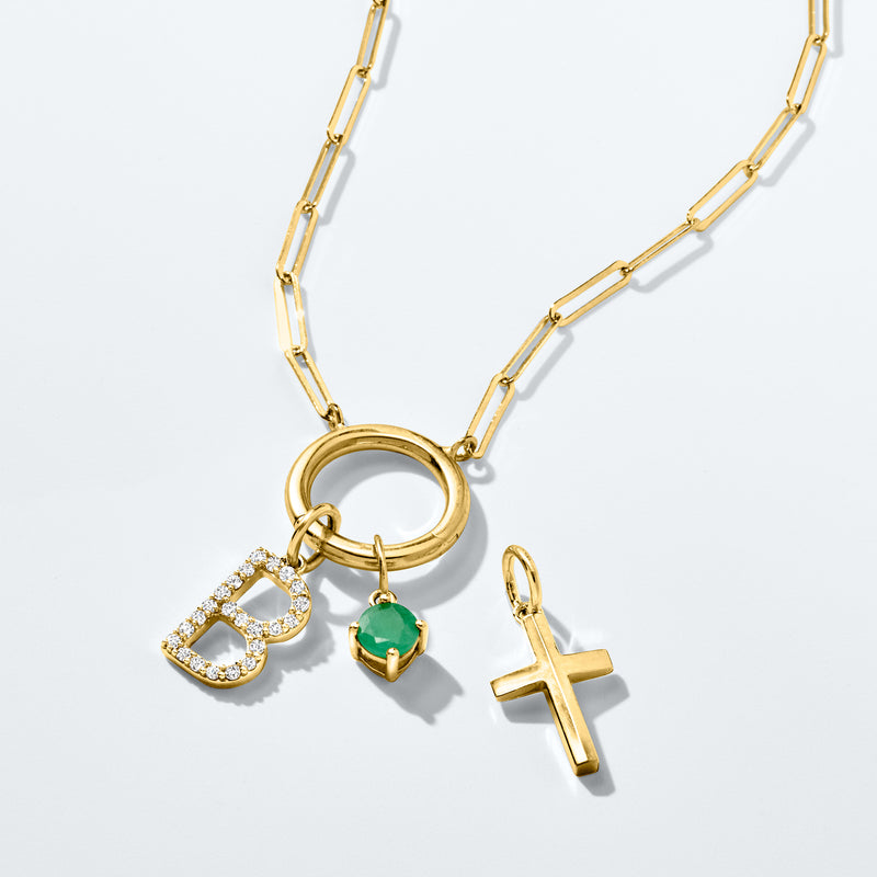 14kt yellow gold layered charm necklace with initial, heart, and green gemstone
