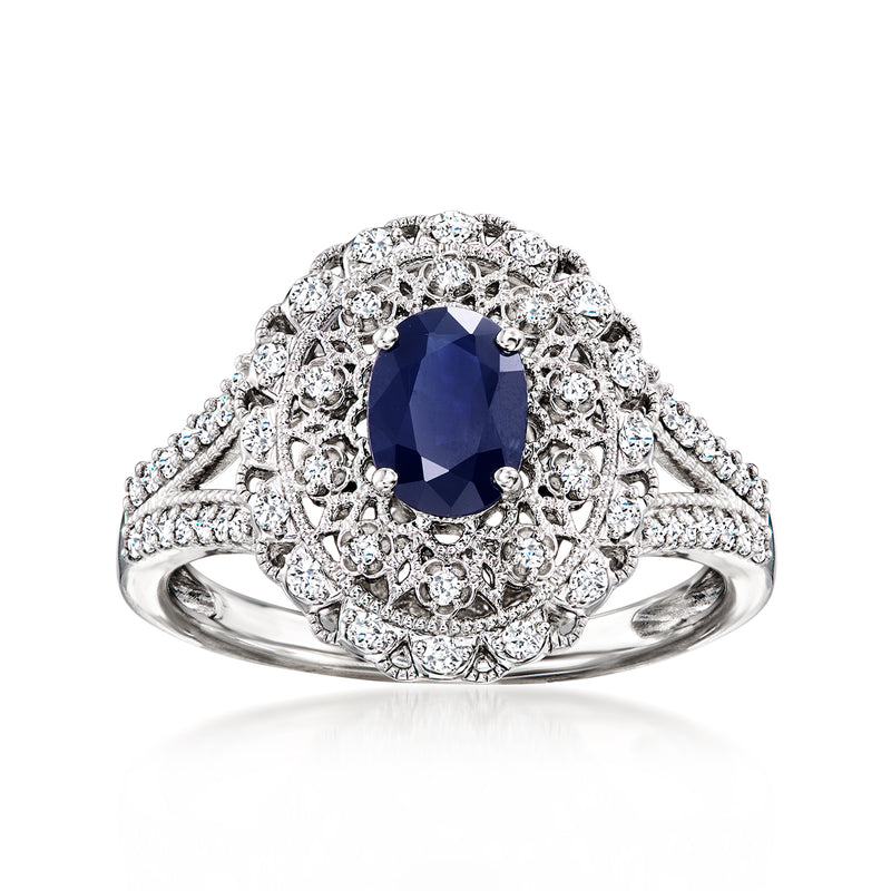 Sterling silver vintage-style ring with oval dark blue sapphire center and diamond halo