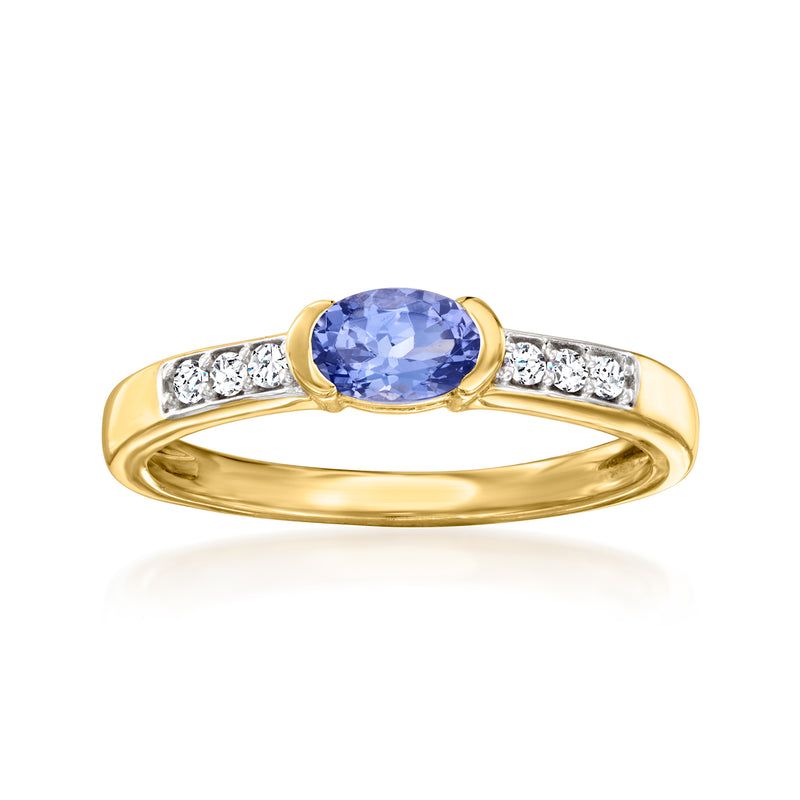 Gold ring with oval blue center stone and white zircon side accents