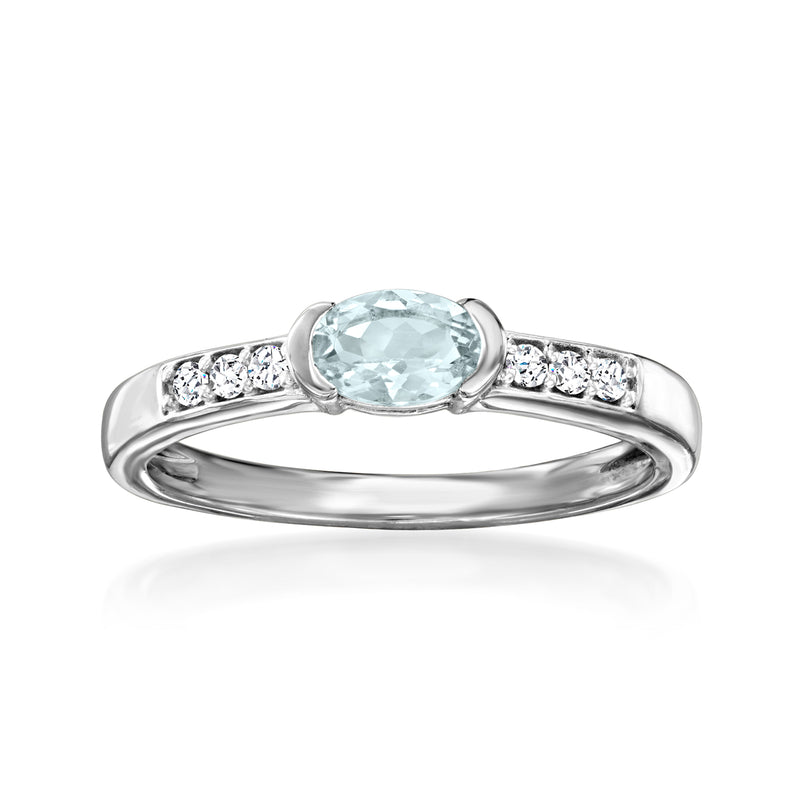 Sterling silver ring with oval light blue aquamarine center and white zircon side accents