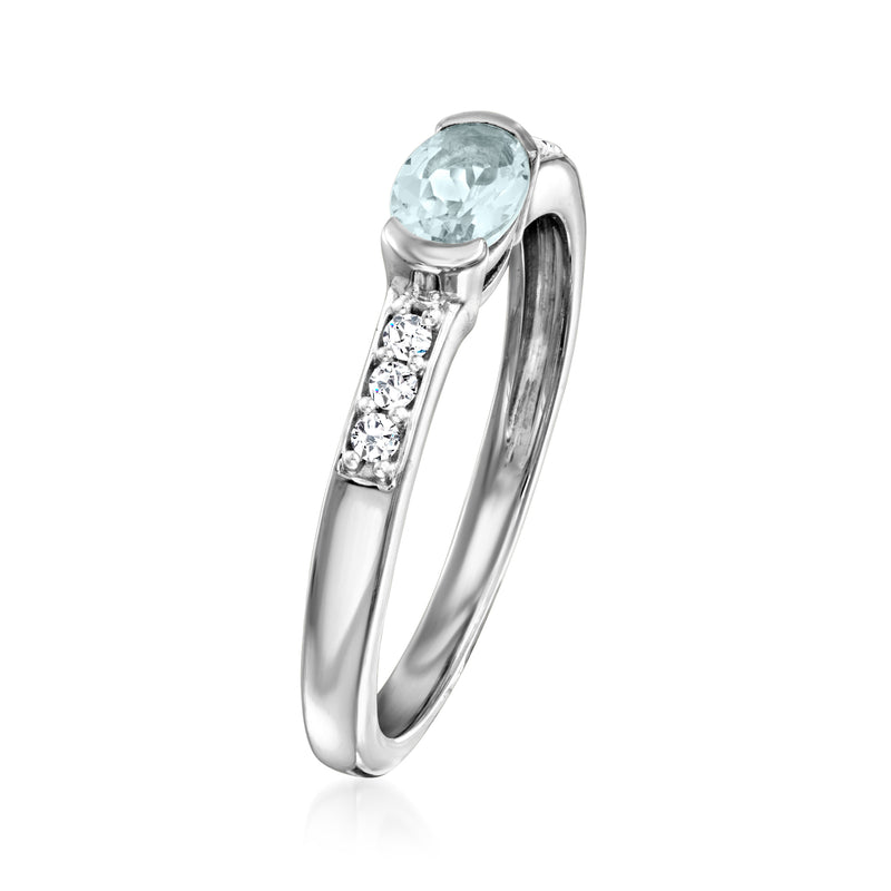 Sterling silver aquamarine ring with oval blue stone and three white zircon accents