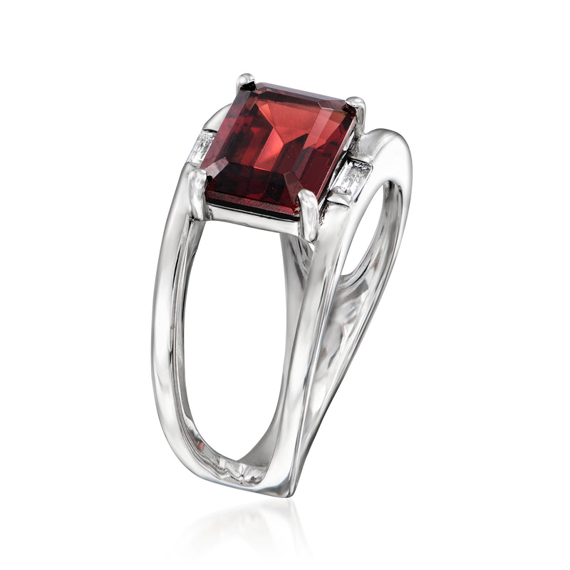 Sterling silver open-space ring with rectangular red garnet stone and side topaz settings