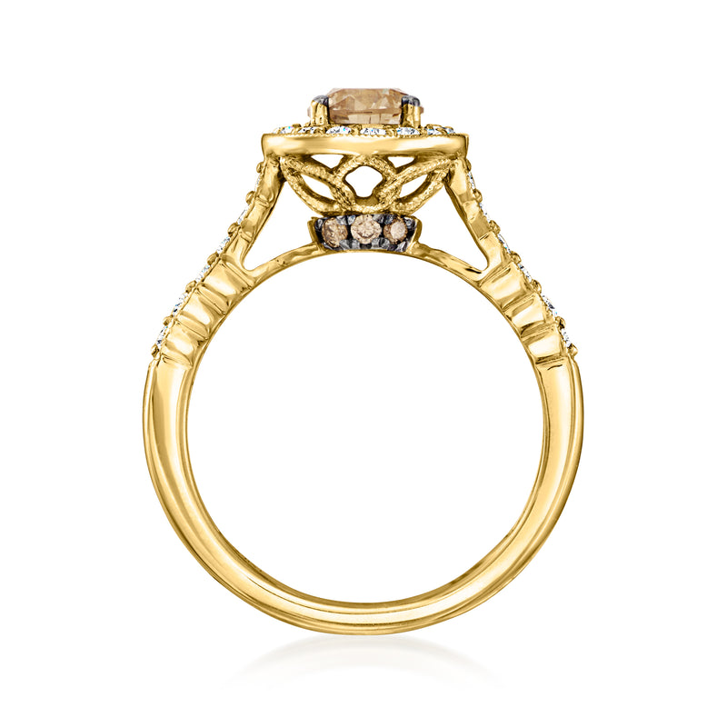 Honey gold ring with openwork shoulders around an oval center stone, diamond accents