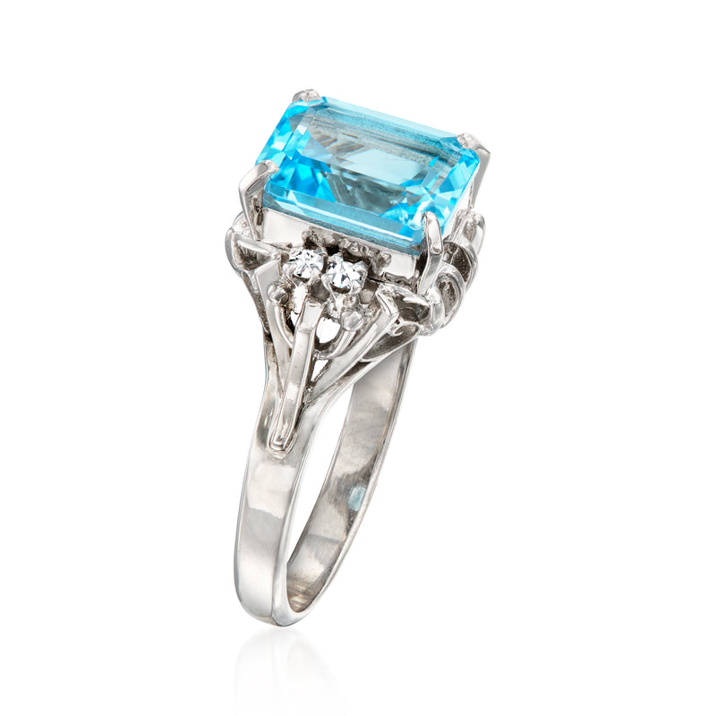 Platinum ring featuring a rectangular sky-blue gemstone with clustered diamond shoulders