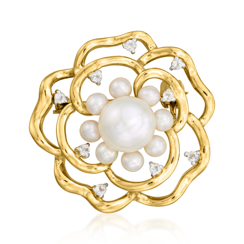 Gold-tone flower pin with round cultured pearl center and clear stone accents