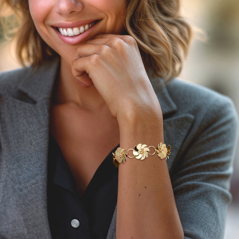 Two-tone gold flower bracelet on wrist, small petal links, vintage 7-inch