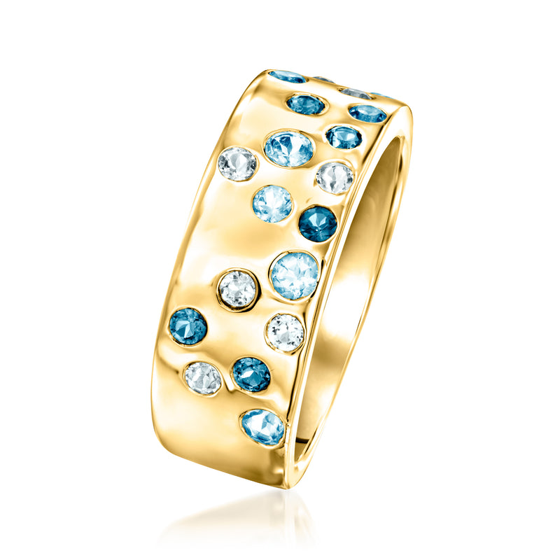 Gold-tone wide band ring with blue and clear gemstones, angled side view