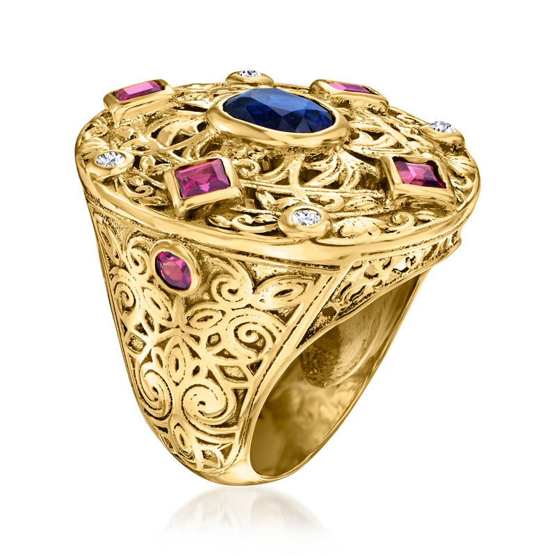 Gold filigree cocktail ring with oval blue center, purple side squares, and white round stones