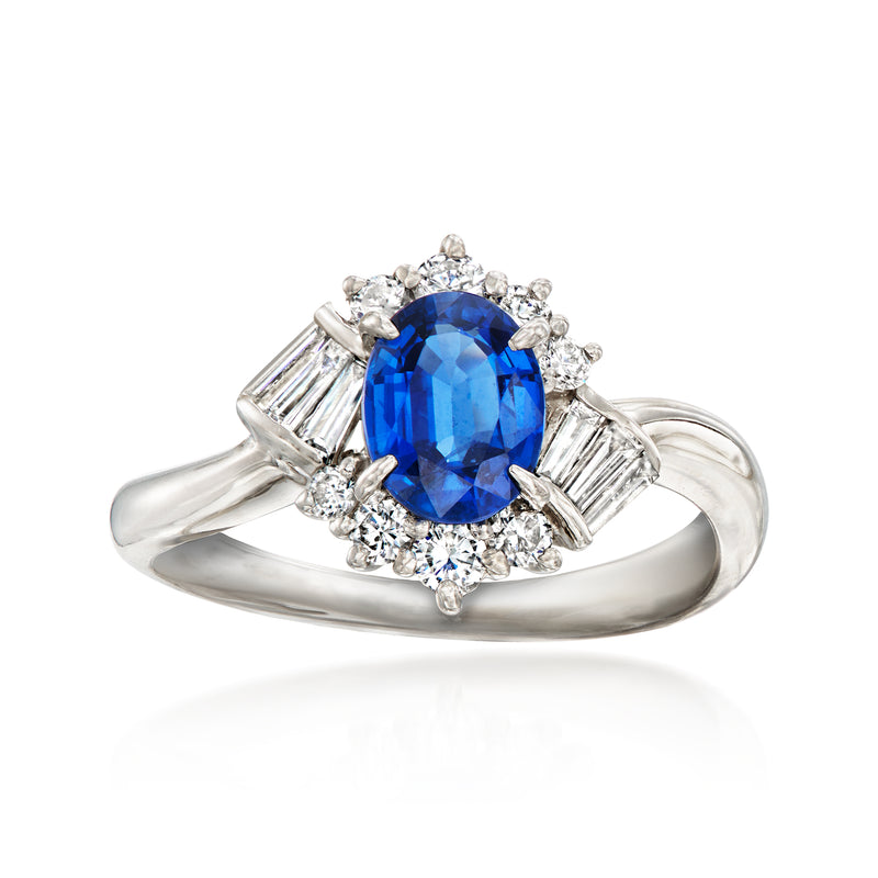 Platinum ring with oval blue sapphire and diamond halo, baguette side accents