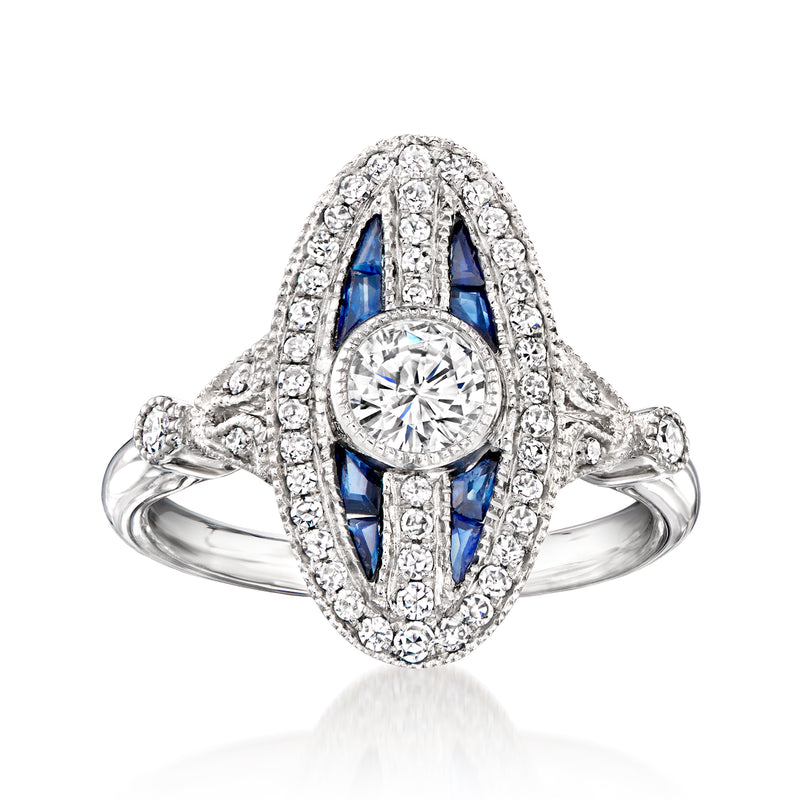 Platinum vintage ring with round diamond center, diamond halo, and blue sapphire accents