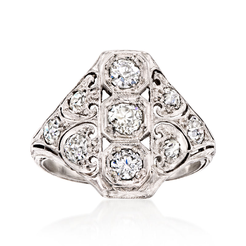 Vintage platinum diamond ring with oval center and three stone cluster, ornate filigree