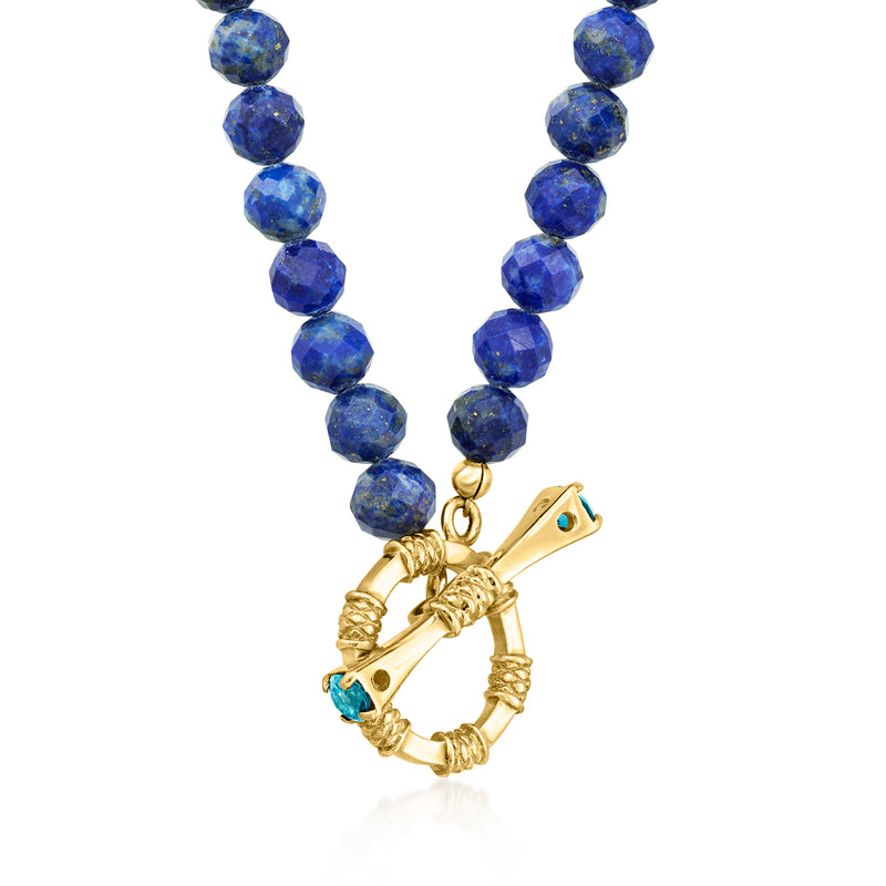 Blue lapis bead necklace with ornate gold-tone toggle and blue topaz drop charm