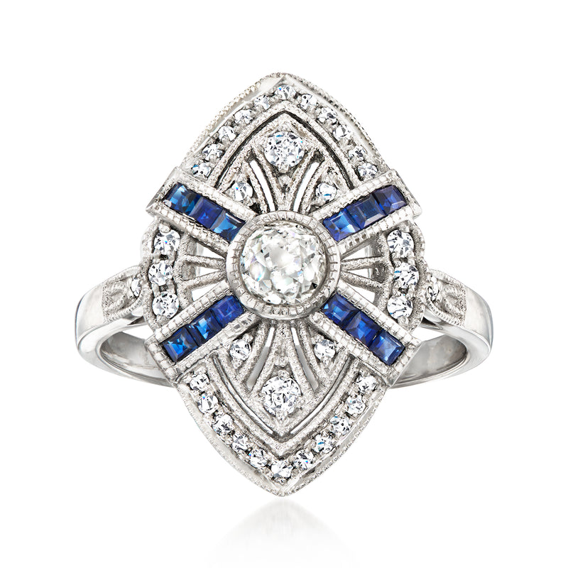 Vintage filigree ring in platinum with round center diamond, blue sapphire cross setting