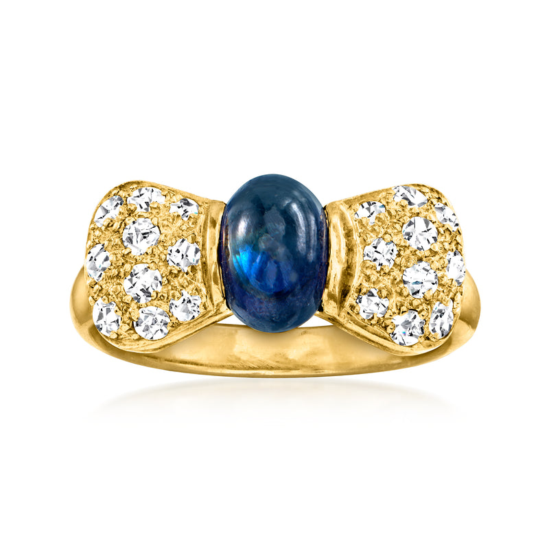 18k yellow gold bow ring with blue sapphire center and diamond cluster sides