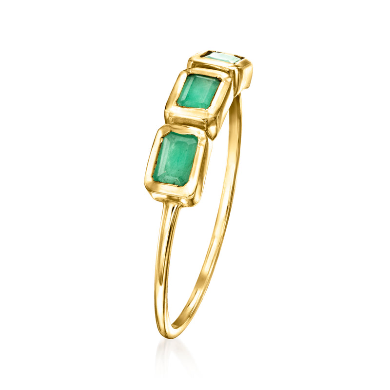 14kt yellow gold three-stone ring with two green emerald-cut settings