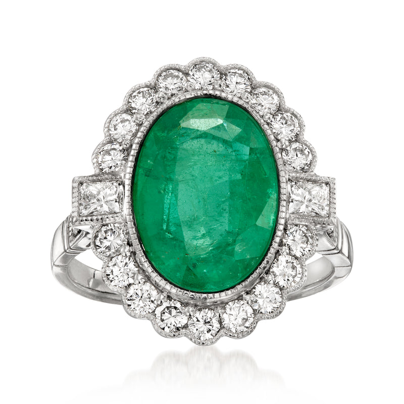 Platinum vintage ring with oval emerald-green gemstone center and diamond halo accents