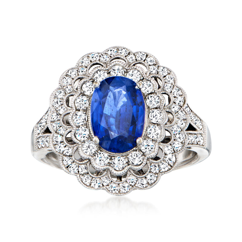 Vintage 18k white gold ring with oval blue sapphire and diamond halo