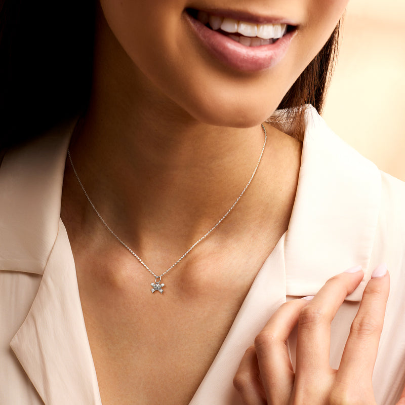 Sterling silver diamond bow charm necklace on a fine chain