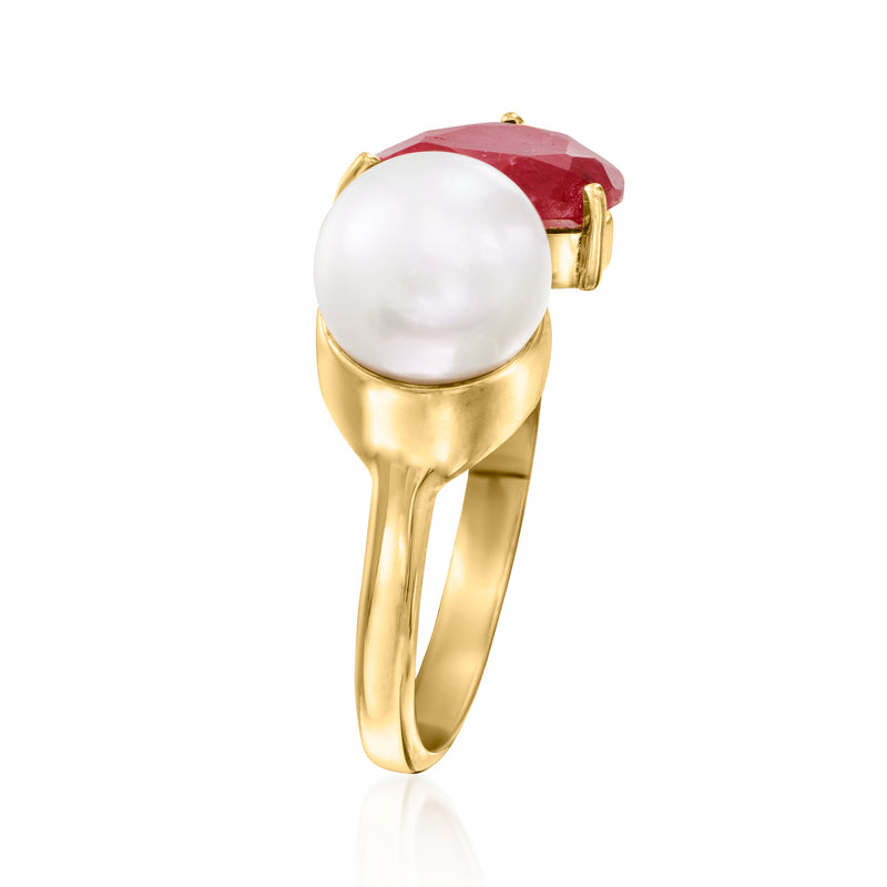 Gold-tone ring with large white pearl and faceted red gem in split band setting