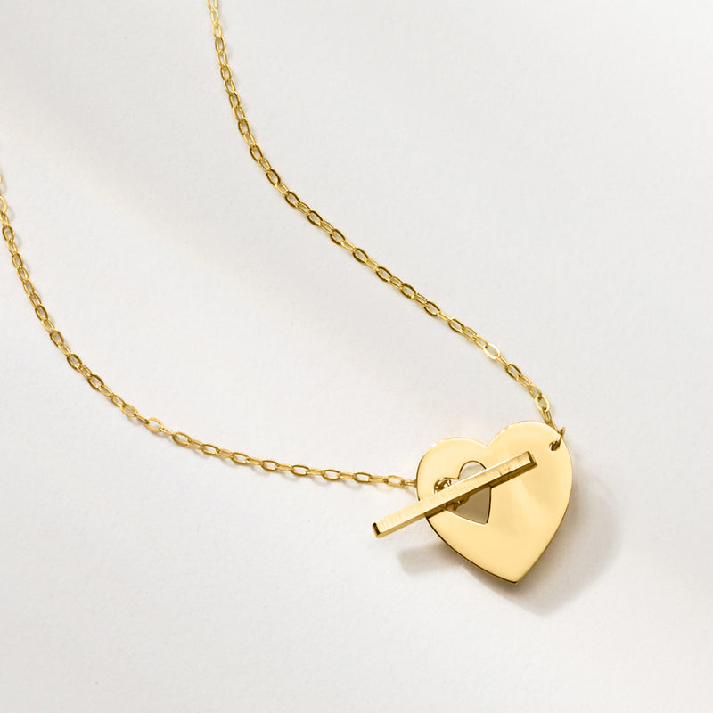Yellow gold heart pendant with toggle bar on a fine link chain necklace