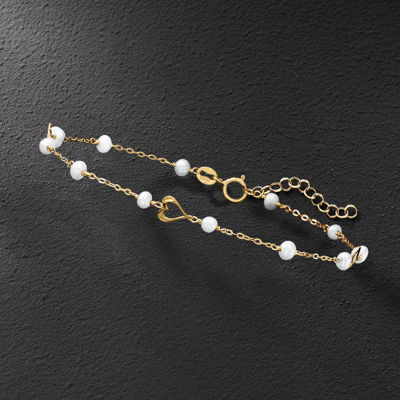 Cultured pearl station bracelet in 10kt yellow gold with heart details and chain links