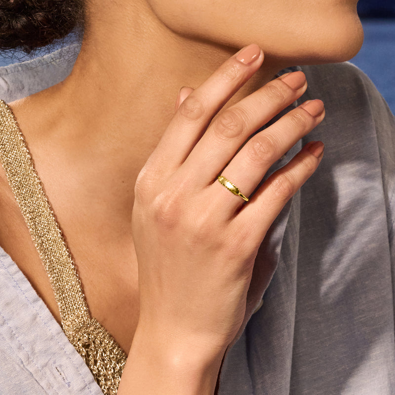 Yellow gold diamond-cut bar ring on finger with slim band and faceted top