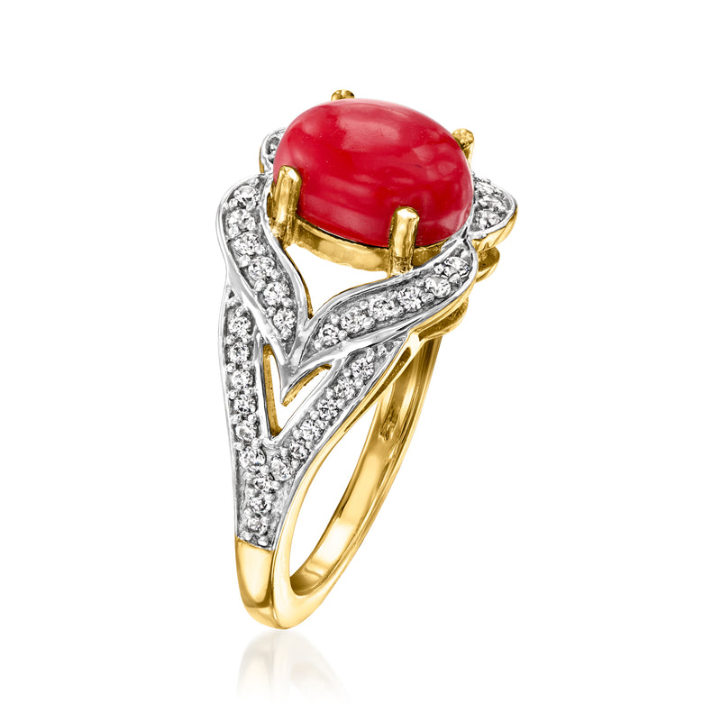 Red oval coral cabochon ring with gold-tone prongs and white zircon detail