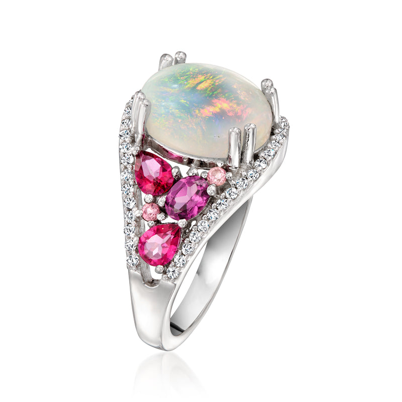 Sterling silver ring with oval opal top and pink stones in curved cluster