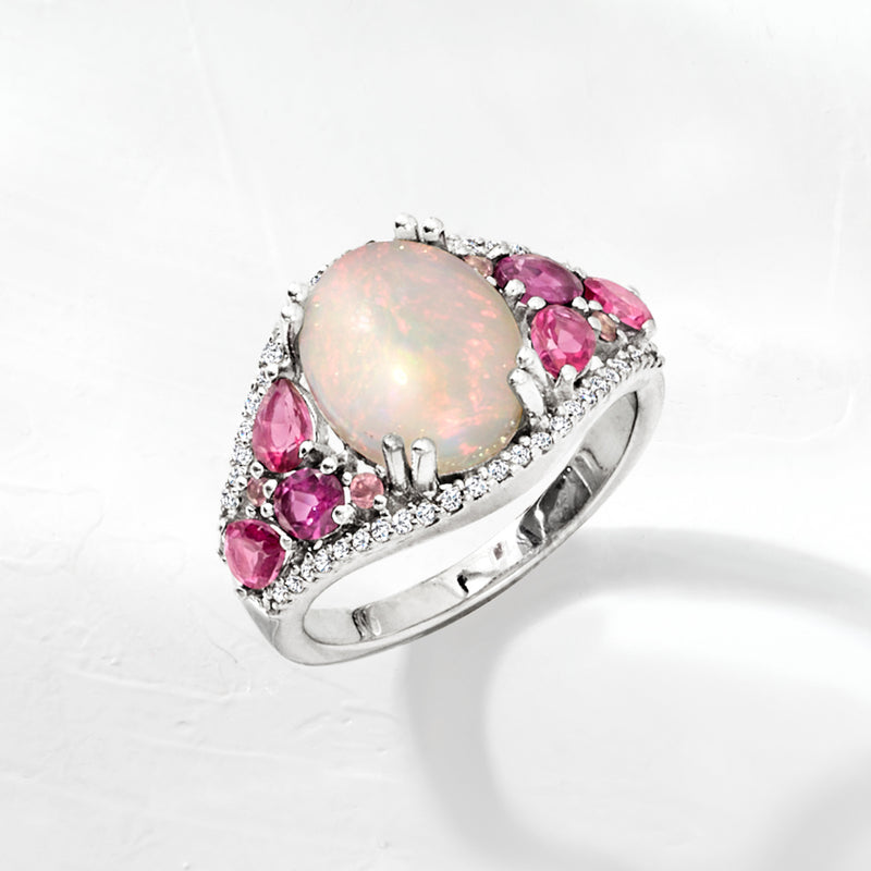 Sterling silver opal and pink gemstone ring, side view of prongs and stone-lined band