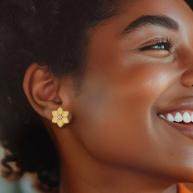 Yellow gold daisy stud earrings with diamond accents on model