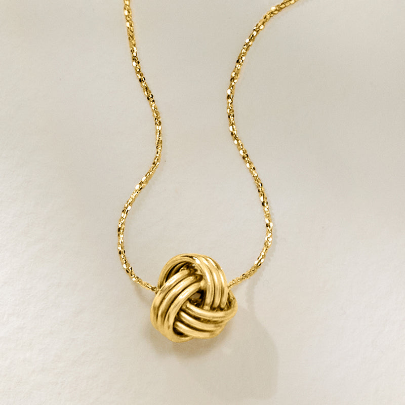 10kt yellow gold love knot pendant necklace close-up with curved chain