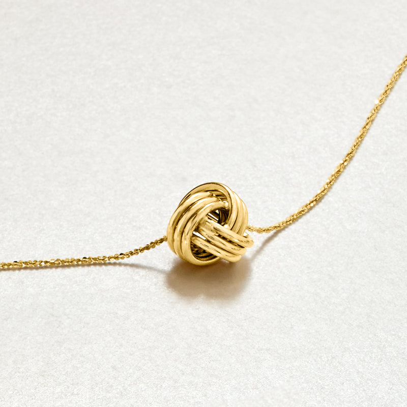 10kt yellow gold love knot pendant necklace side view of twisted knot