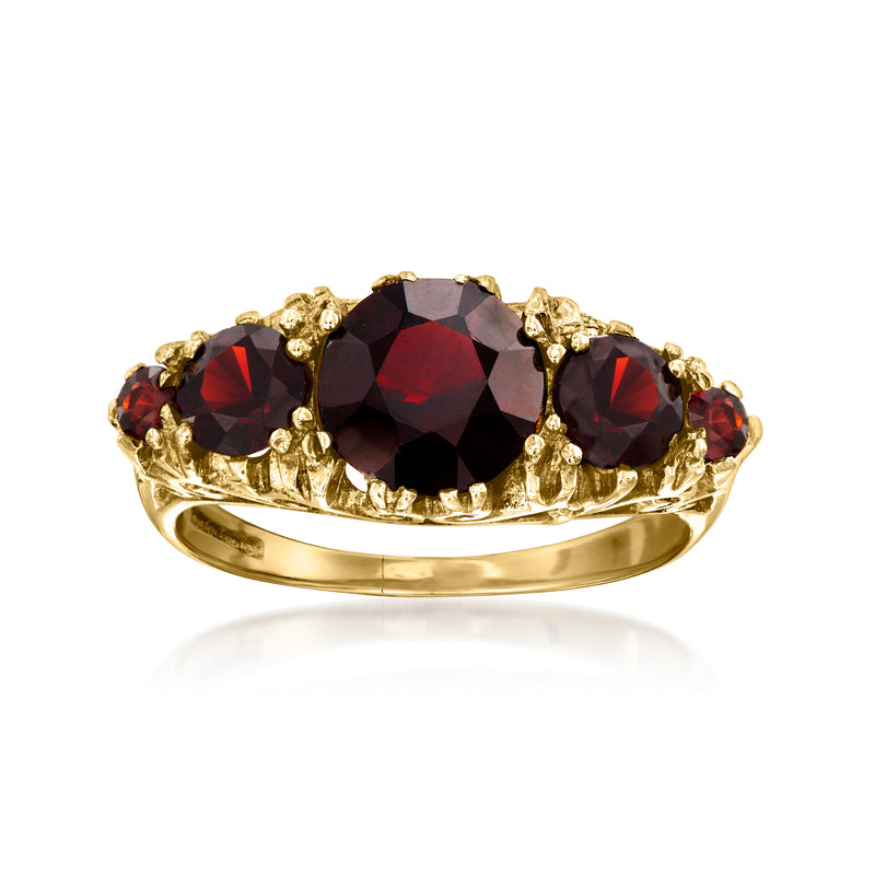 Vintage 9kt yellow gold garnet ring with oval dark-red center and red side stones